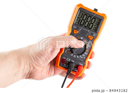 lcd screen digital electrical multimeter in left hand, isolated on white background, mockup with all on 84943182