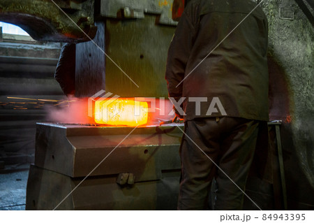 close-up picture of hot steel free forging process with big mechanical hammer machine close-up picture of hot steel free forging process with big mechanical hammer machine 84943395