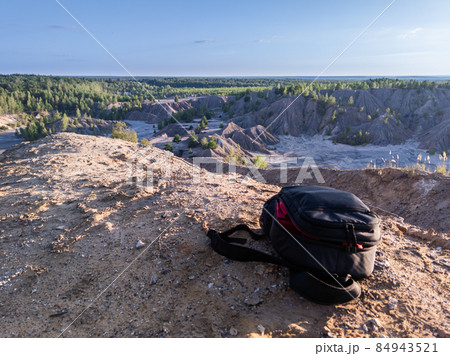 small black backpack on top of the hill at summer daytime small black backpack on top of the hill at summer daytime 84943521