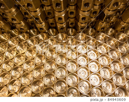 an abstract industrial close-up background of shiny brass metal threaded hexagonal fitting parts 84943609
