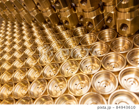 shiny brass metal threaded hexagonal fitting parts, abstract perspective industrial close-up background 84943610