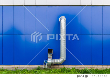 industrial grade air extraction duct with electrical motor on blue wall industrial grade air extraction duct with electrical motor on blue wall 84943638