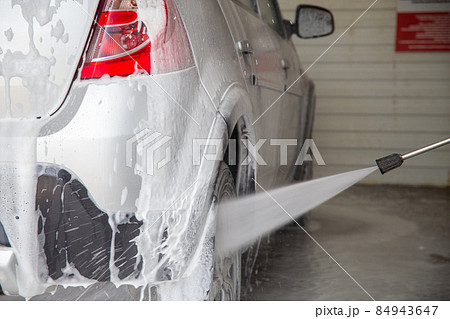 a closeup view of process of indoor wet car washing 84943647
