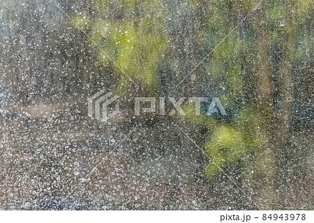 dirty window glass at sunny summer or spring weather close-up with selective focus and blur dirty window glass at sunny summer or spring weather close-up with selective focus and blur 84943978