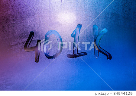 the word 401k - an employer-sponsored defined-contribution pension account plan - handwritten on night foggy window glass 84944129