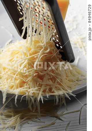 Grated cheese and grater. Grated cheese and grater. 84946729