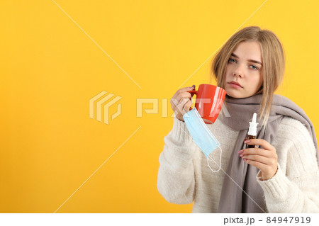 Ill young woman on yellow background, seasonal cold concept 84947919