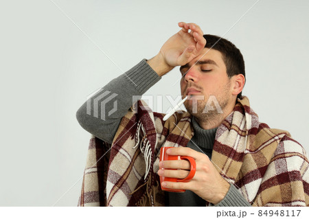 Ill young man on light background, seasonal cold concept Ill young man on light background, seasonal cold concept 84948117