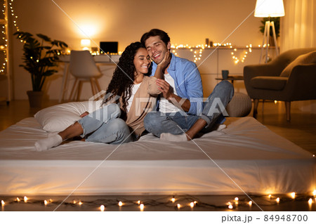 Happy Couple In Love Embracing Sitting On Mattress At Home 84948700