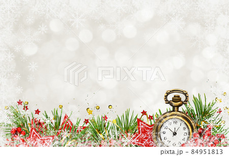 Christmas decorative border with pine tree, clock and red wooden stars on white bokeh background with snowflakes 84951813