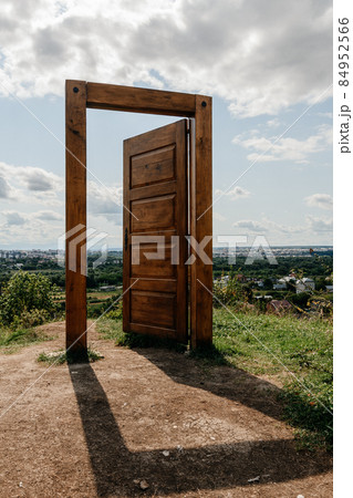 Doors with a door frame stand in the field, Ukrainian Vovchynets mountains. 84952566