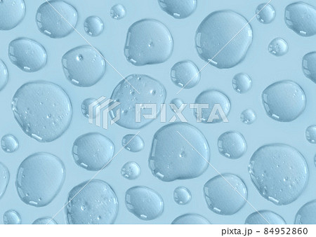 Blue doses of acid, hyaluronic moisturizing serum or gel on a monochrome background. Abstract backdrop pattern. Beauty product wallpaper. Cosmetics or healthcare protection concept.  84952860