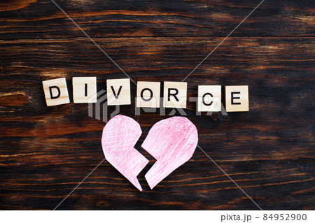 broken heart with inscription divorce made by wooden blocks on wooden background. broken heart with inscription divorce made by wooden blocks on wooden background. 84952900