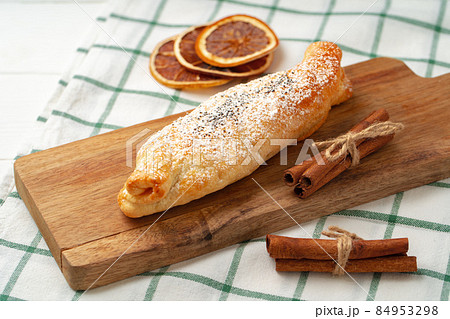 Traditional apple strudel on wooden board, close up 84953298