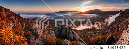 Sunset in the mountains in foggy weather Sunset in the mountains in foggy weather 84953426