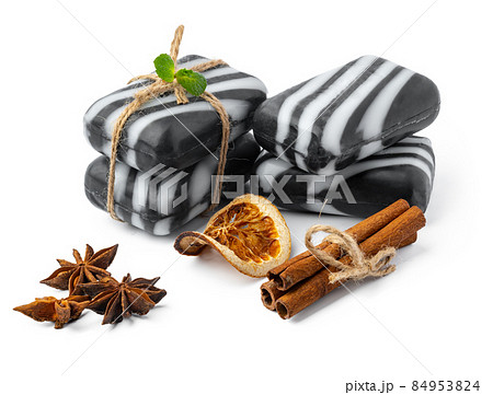Pieces of natural black handmade soap on white background Pieces of natural black handmade soap on white background 84953824