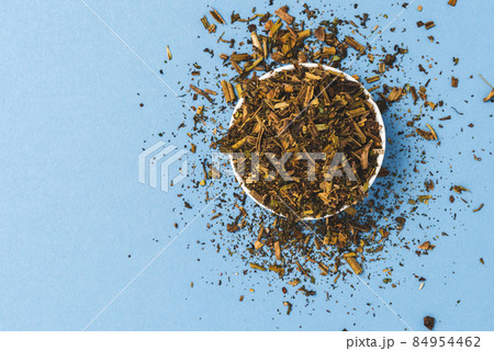 Dried greater celandine on blue background. Top view 84954462