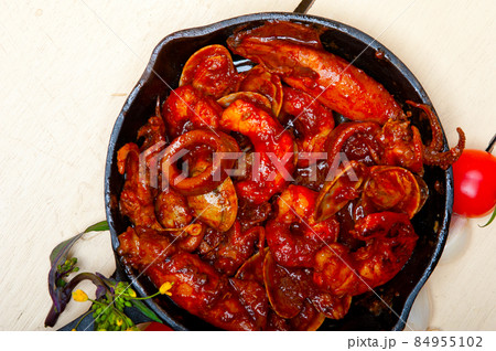 fresh seafoos stew on an iron skillet 84955102