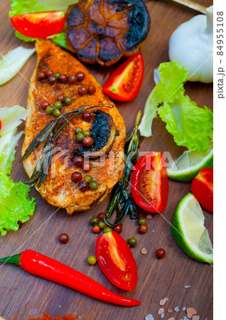 wood fired hoven cooked chicken breast on wood board 84955108
