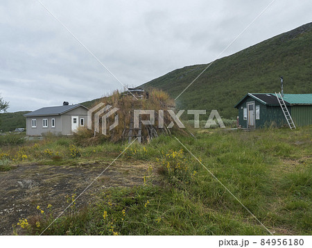 Sami village Staloluokta at Virihaure lake with houses and cottage, mountains and birch trees. summer moody and foggy day at Padjelantaleden hiking trail. Sweden Lapland landscape 84956180