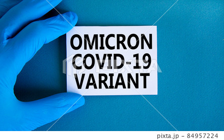 New covid-19 omicron variant strain symbol. Hand in blue glove with white card. Concept words Omicron covid-19 variant. Medical and COVID-19 omicron variant strain concept. Copy space. 84957224