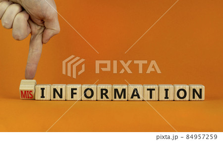 Information or misinformation symbol. Businessman turns cubes and changes the word misinformation to information. Orange background, copy space. Business and information or misinformation concept. Information or misinformation symbol. Businessman turns cubes and changes the word misinformation to information. Orange background, copy space. Business and information or misinformation concept. 84957259