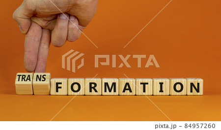 Formation or transformation symbol. Businessman turns cubes and changes the word formation to transformation. Beautiful orange background. Business, formation or transformation concept. Copy space. Formation or transformation symbol. Businessman turns cubes and changes the word formation to transformation. Beautiful orange background. Business, formation or transformation concept. Copy space. 84957260