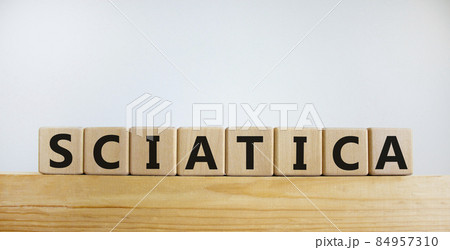 Sciatica symbol. Wooden cubes with word 'sciatica'. Beautiful white background. Medical and sciatica concept. Copy space. Sciatica symbol. Wooden cubes with word 'sciatica'. Beautiful white background. Medical and sciatica concept. Copy space. 84957310