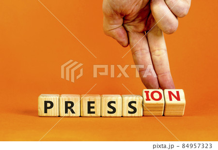 Pression to free press symbol. Businessman turns wooden cubes, changes the word pression to press. Beautiful orange table, orange background. Business and pression to free press concept. Copy space. Pression to free press symbol. Businessman turns wooden cubes, changes the word pression to press. Beautiful orange table, orange background. Business and pression to free press concept. Copy space. 84957323