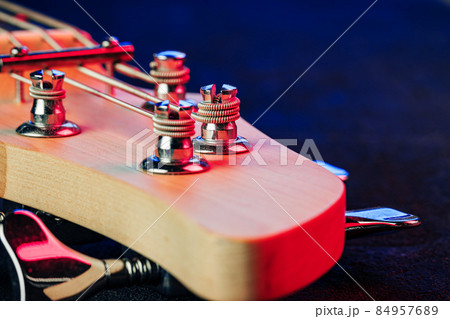 Guitar headstock with tuners on dark background Guitar headstock with tuners on dark background 84957689