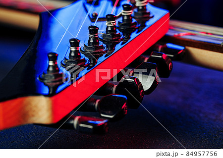 Guitar headstock with tuners on dark background Guitar headstock with tuners on dark background 84957756