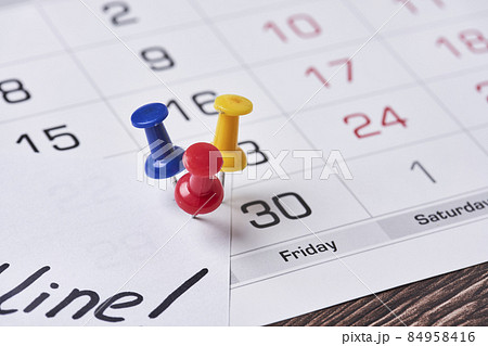 Deadline concept. A paper with Deadline text pinned on monthly calendar. White card with Deadline text pinned with push pins on calendar date. Last day, Last chance concepts 84958416