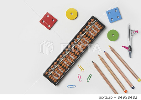 Creative lay out of mental mathematics items. Mental arithmetic for kids. School items for kids. Abacus with school supplies, drawing compass on colored background. Mental mathematics, math concept 84958482