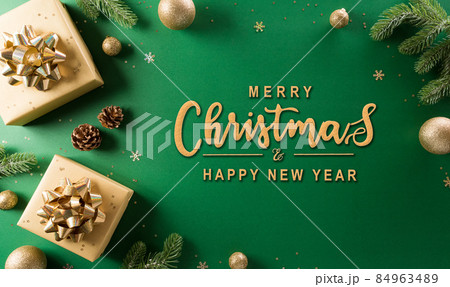 Christmas and new year background concept. Top view of Christmas gift box, christmas ball and snowflake on green background. Christmas and new year background concept. Top view of Christmas gift box, christmas ball and snowflake on green background. 84963489