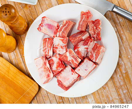 Pieces of uncooked pork ribs on table Pieces of uncooked pork ribs on table 84965247