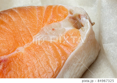 Proper healthy nutrition. Raw red salmon fish slice close-up with texture. Product containing vitamin D, A, B, C, PP phosphorus, iodine, calcium, potassium, sodium, magnesium, zinc, fluorine, omega-3 Proper healthy nutrition. Raw red salmon fish slice close-up with texture. Product containing vitamin D, A, B, C, PP phosphorus, iodine, calcium, potassium, sodium, magnesium, zinc, fluorine, omega-3 84967325