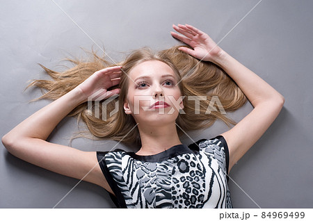 Beautiful stylish woman lying on floor Beautiful stylish woman lying on floor 84969499