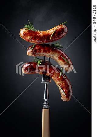 Grilled Bavarian sausages with rosemary. 84972119