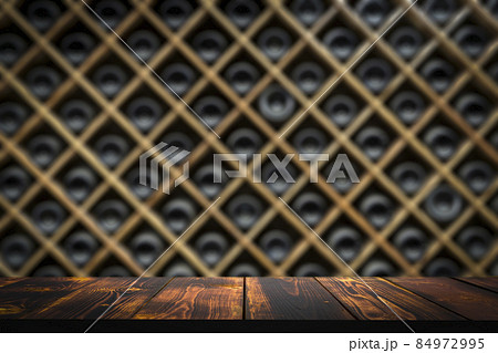 Wine wooden table background. Wine cellar with blurred bottles and wooden rustic table  84972995