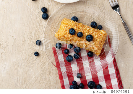 Piece of russian honey cake medovik served with berries 84974591