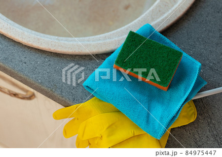 Cleaning sponge and rag on kitchen counter Cleaning sponge and rag on kitchen counter 84975447