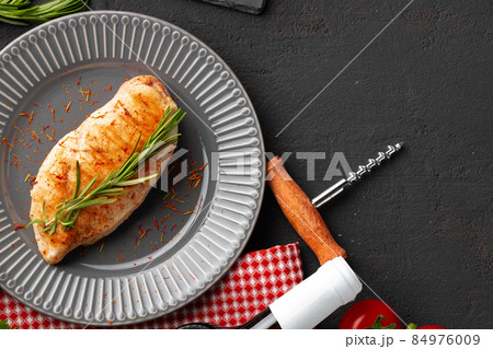 Grilled chicken breast served on black table 84976009