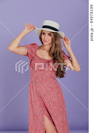 beautiful blonde woman in a summer dress in a white room 84978199