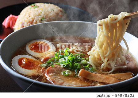 湯気の上がるシズル感のあるラーメン 84978202