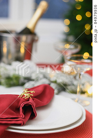 Christmas table setting, red towel with gold ring. Family holiday dinner or New Year party. Christmas table setting, red towel with gold ring. Family holiday dinner or New Year party. 84979936