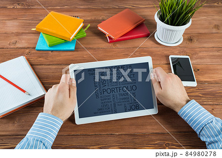 Businessman with a computer tablet at a work desk Businessman with a computer tablet at a work desk 84980278