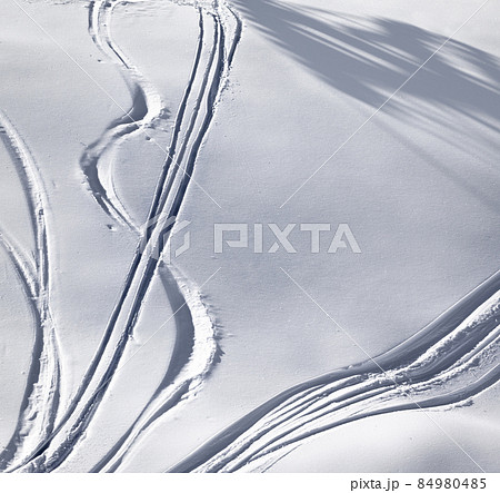 Off-piste slope with track from ski and snowboard on sunny evening Off-piste slope with track from ski and snowboard on sunny evening 84980485