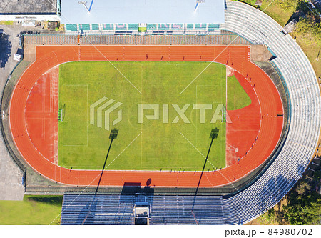 Aerial drone top down view of soccer stadium. Football stadium  with running field  shot with drone at Phuket Thailand 84980702