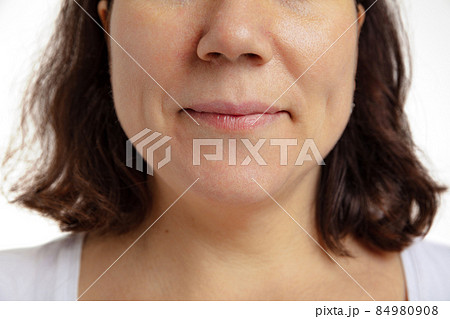 Close-up of female mouth with closed lips without makeup. Anti-aged cosmetology, medicine, dental health. Detailed. Close-up of female mouth with closed lips without makeup. Anti-aged cosmetology, medicine, dental health. Detailed. 84980908