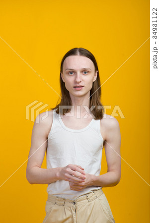 Androgyn young man in men outfit indoors. Studio shot Androgyn young man in men outfit indoors. Studio shot 84981122